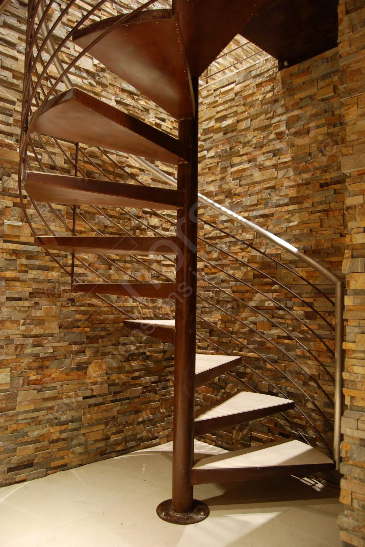 Norstone Ochre Stacked Stone Rock Panels in stairwell of spiral staircase of an underground Wine Cellar in California